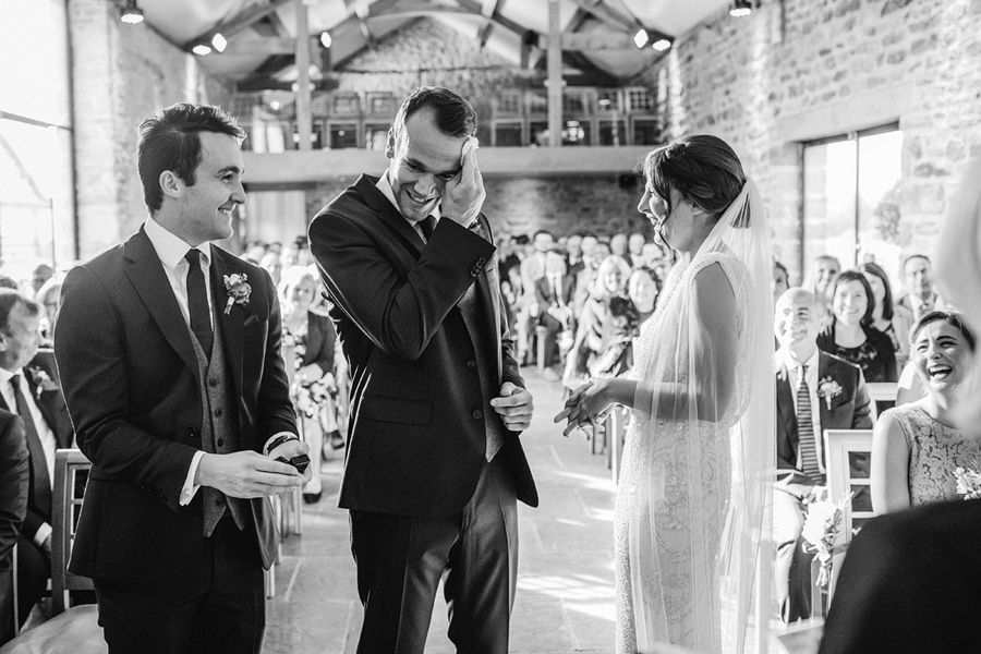 bride and groom nervously exchange their vows - photographed by Fawsley Hall wedding photographer