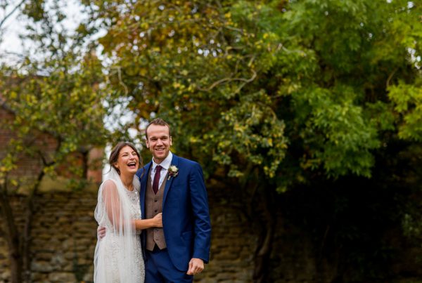 Cotswold wedding photographer Elliot W Patching taking shot of bride and groom laughing