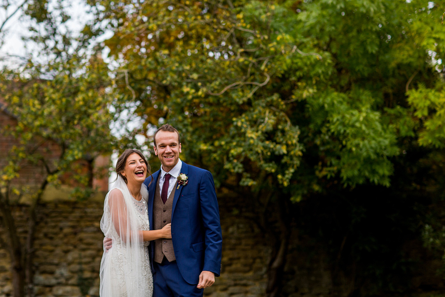 Cotswold wedding photographer Elliot W Patching taking shot of bride and groom laughing