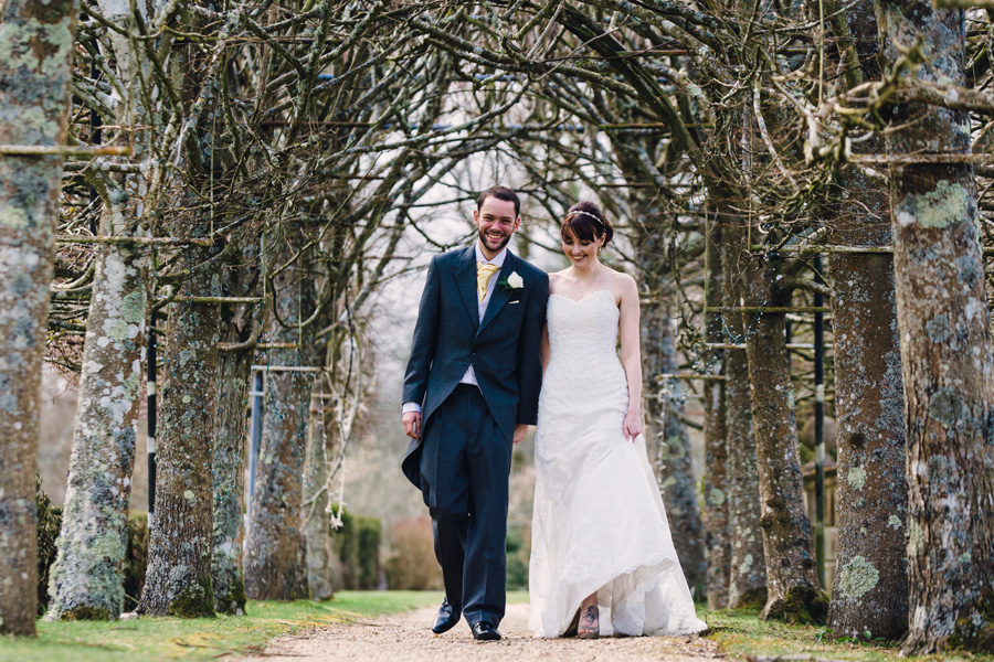 a loving couple takes a walk through some trees