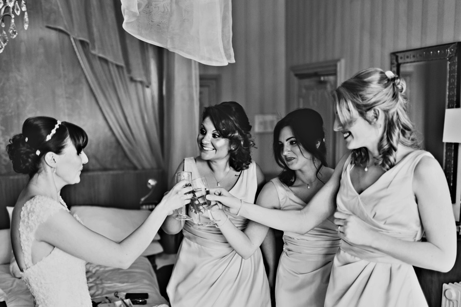 a bride and her bridesmaids drink champagne