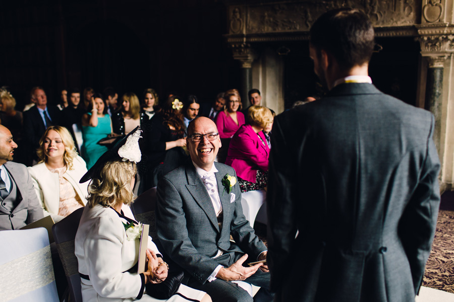 the father of the groom laughs