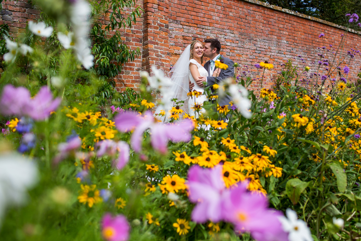 a bride and groom surrounded by flowers