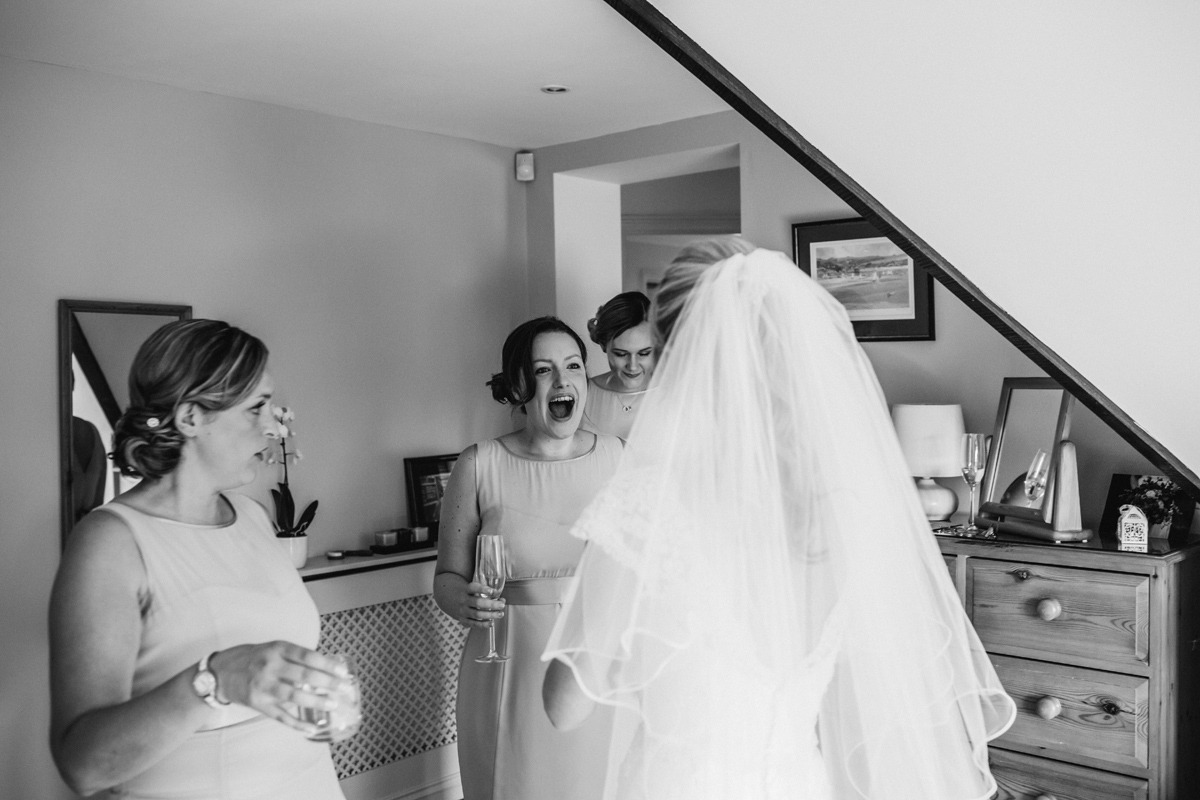 bridesmaids see the wedding dress for the first time