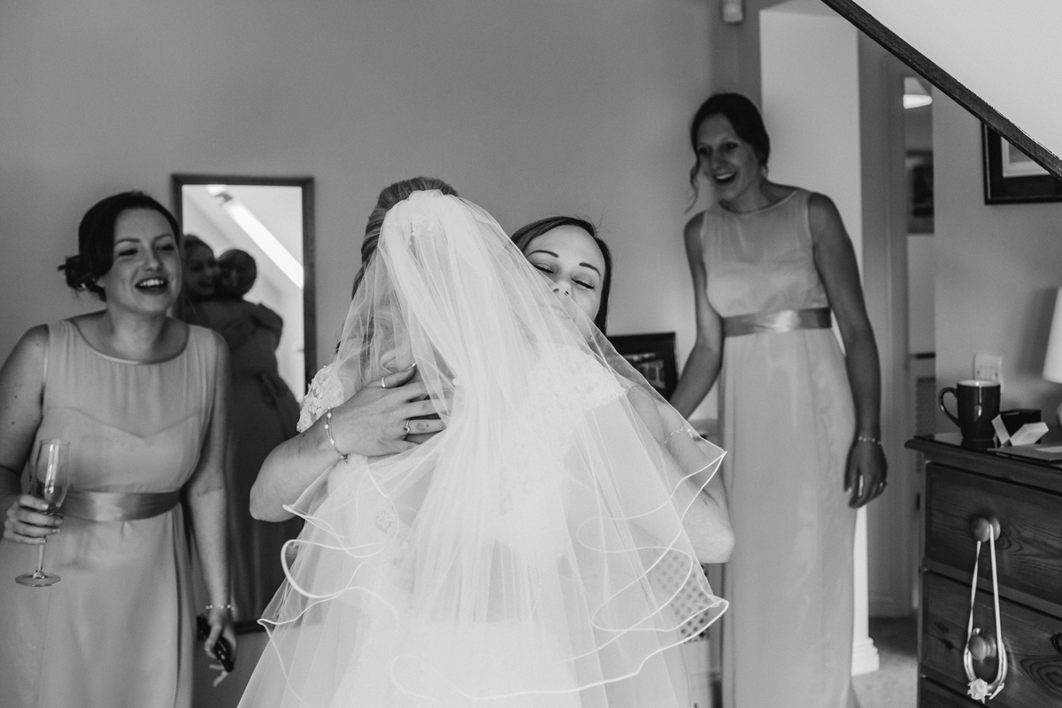 a bridesmaid hugs a bride to be