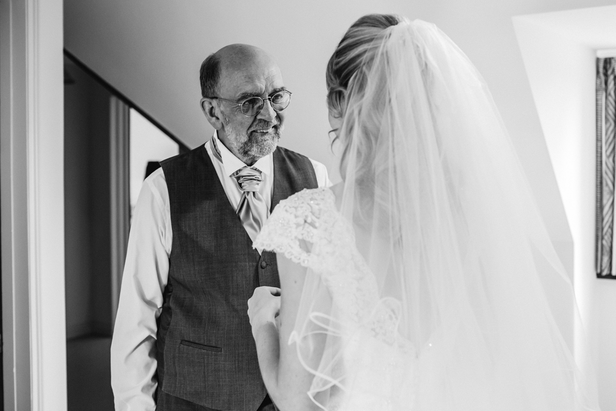 the bride and father of the bride share a moment