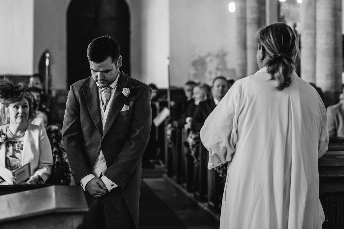 a nervous groom awaits his bride