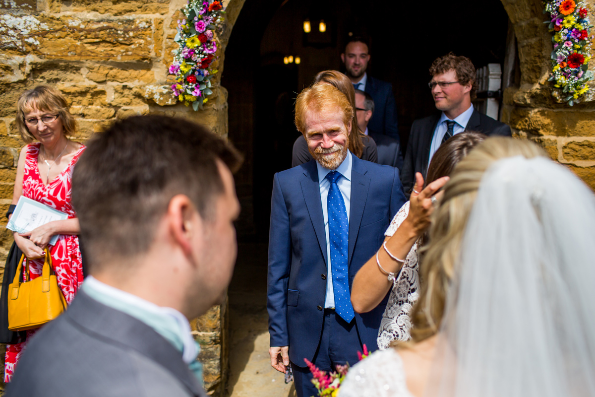 wedding guests leave the church