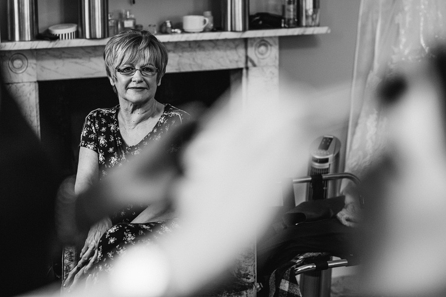 mother of the bride watching her daughter on her wedding day