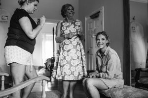 a bridesmaid smiles on the morning of a wedding