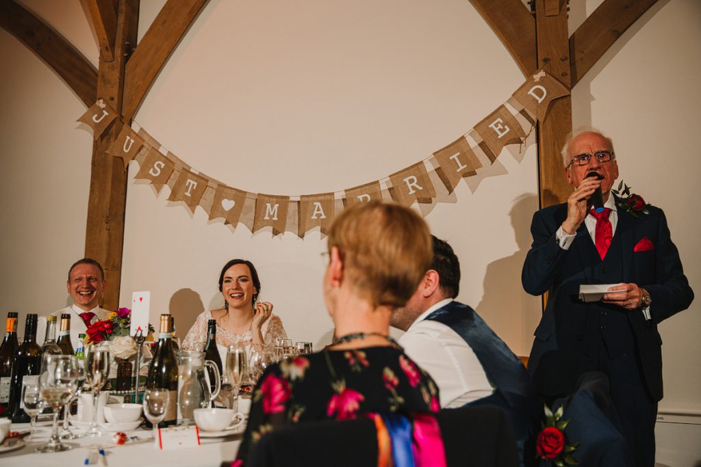 a bride laughs at her fathers wedding speech
