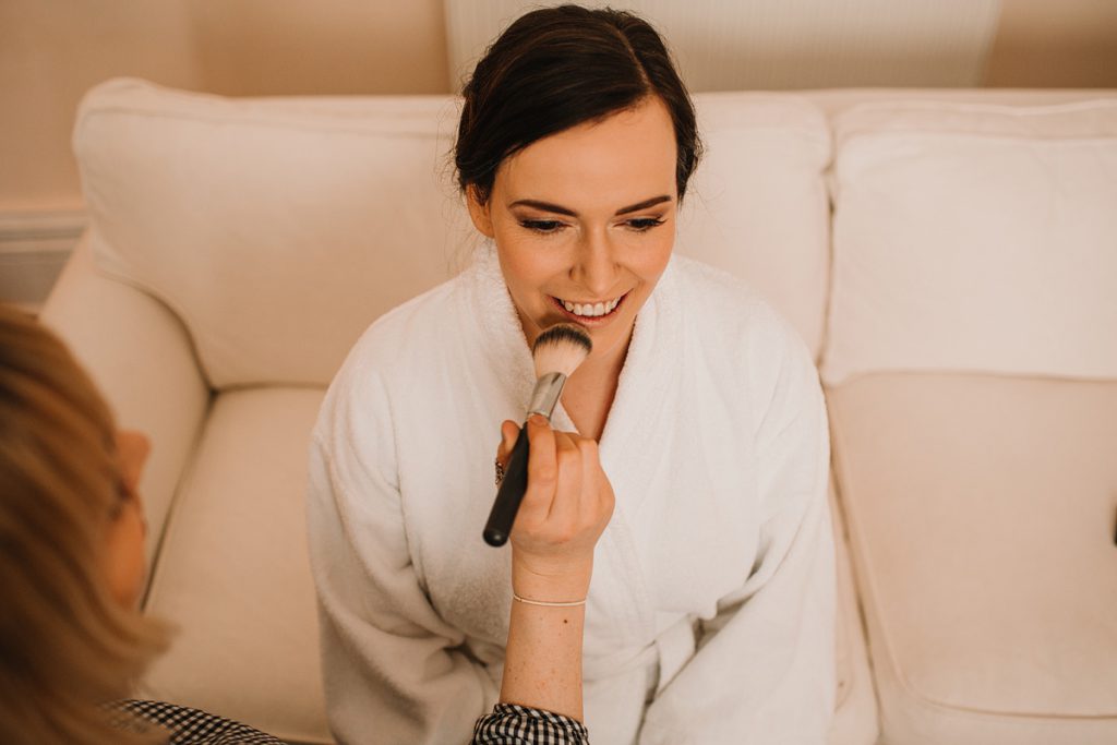 a bride having her makeup applied