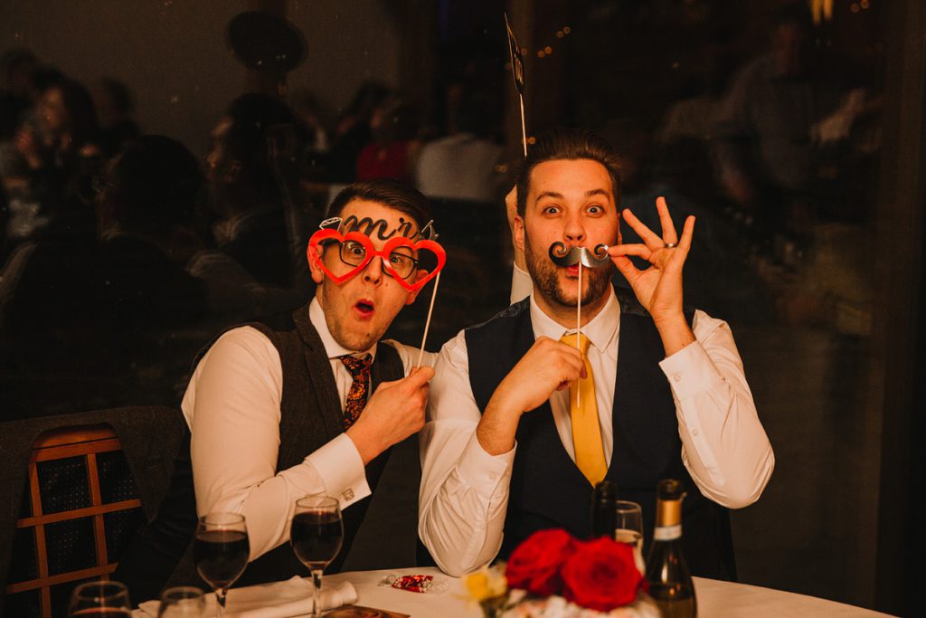 a funny photography od two men on a wedding day