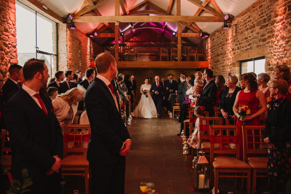 a bride walks down the aisle