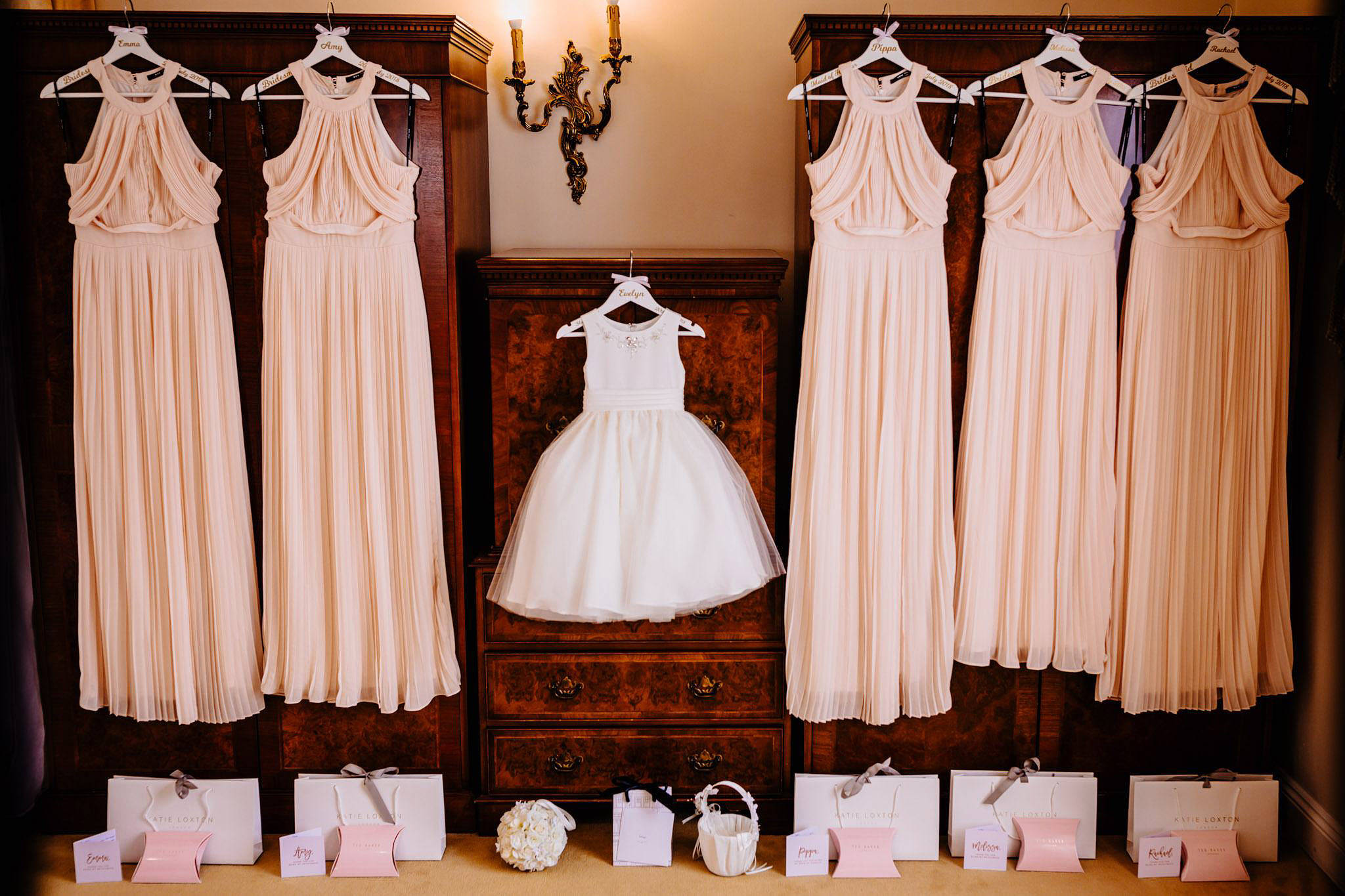 wedding dresses hung up on a chest of drawers