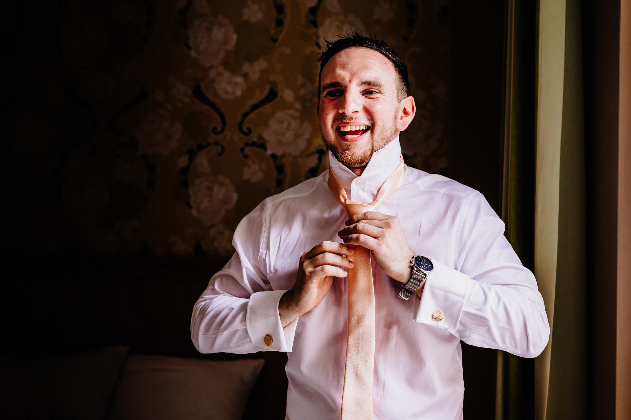 a groom laughing