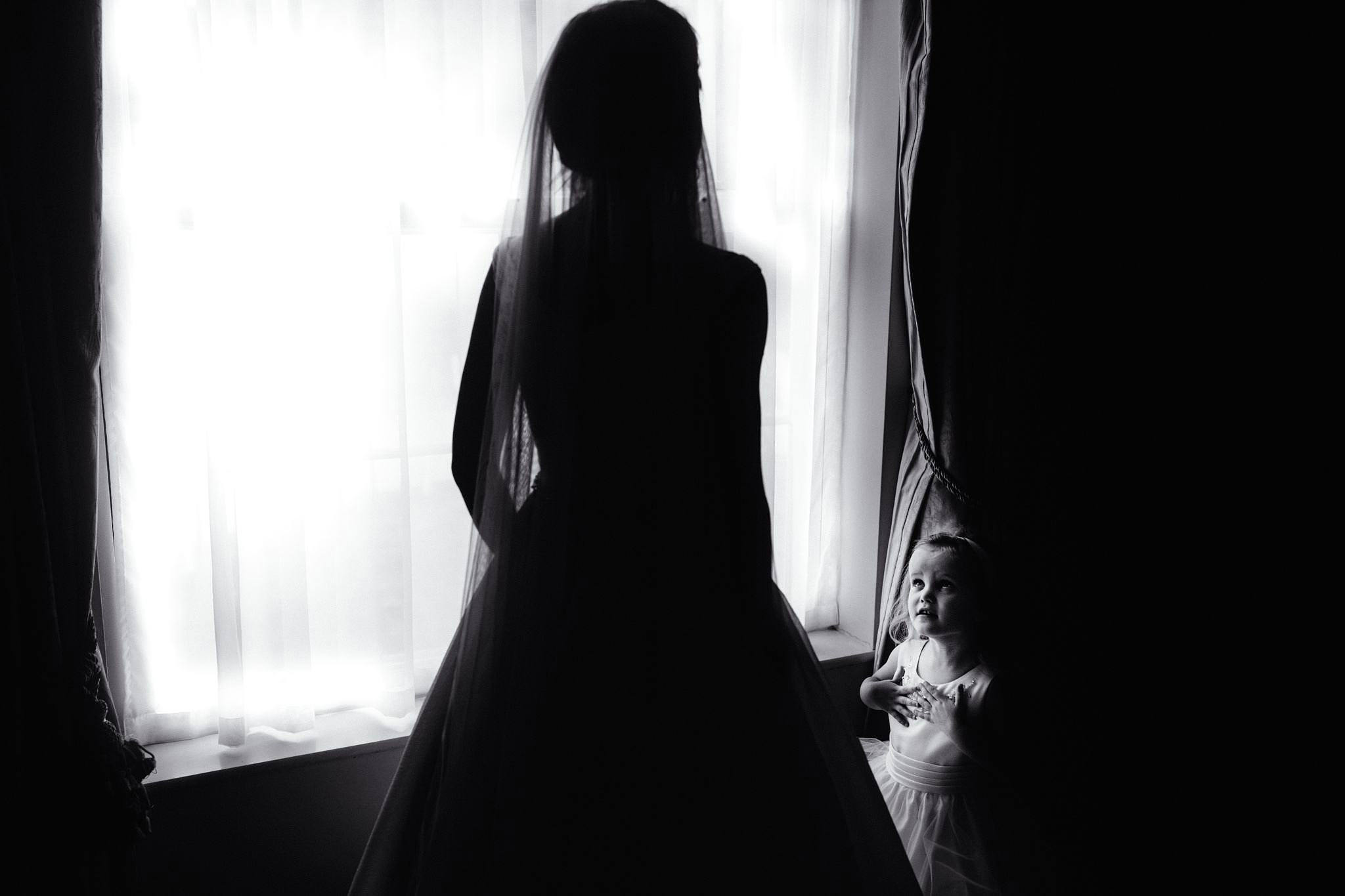 a flower girl looking at a bride