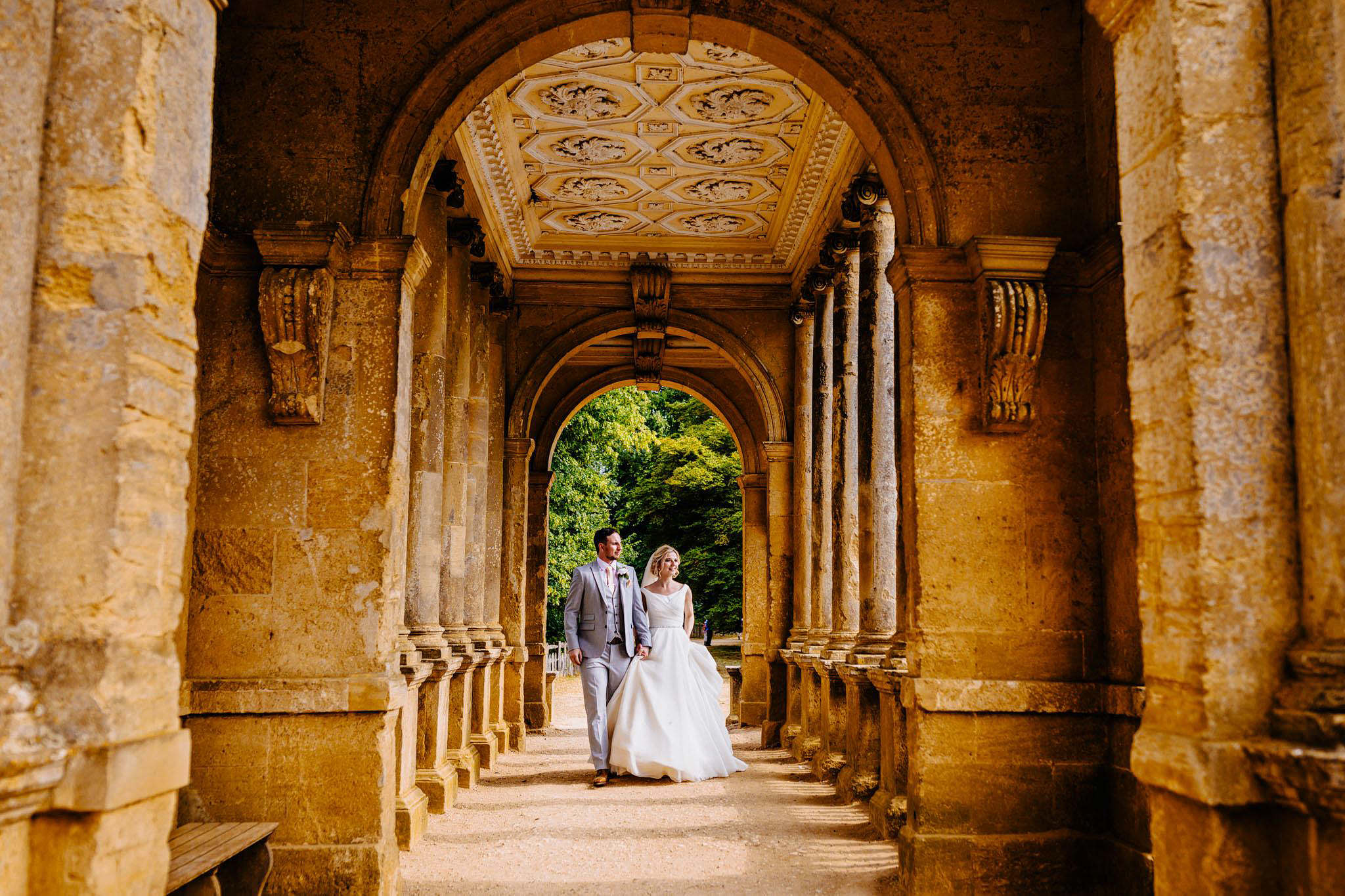 a bride and groom taking a scenic walk