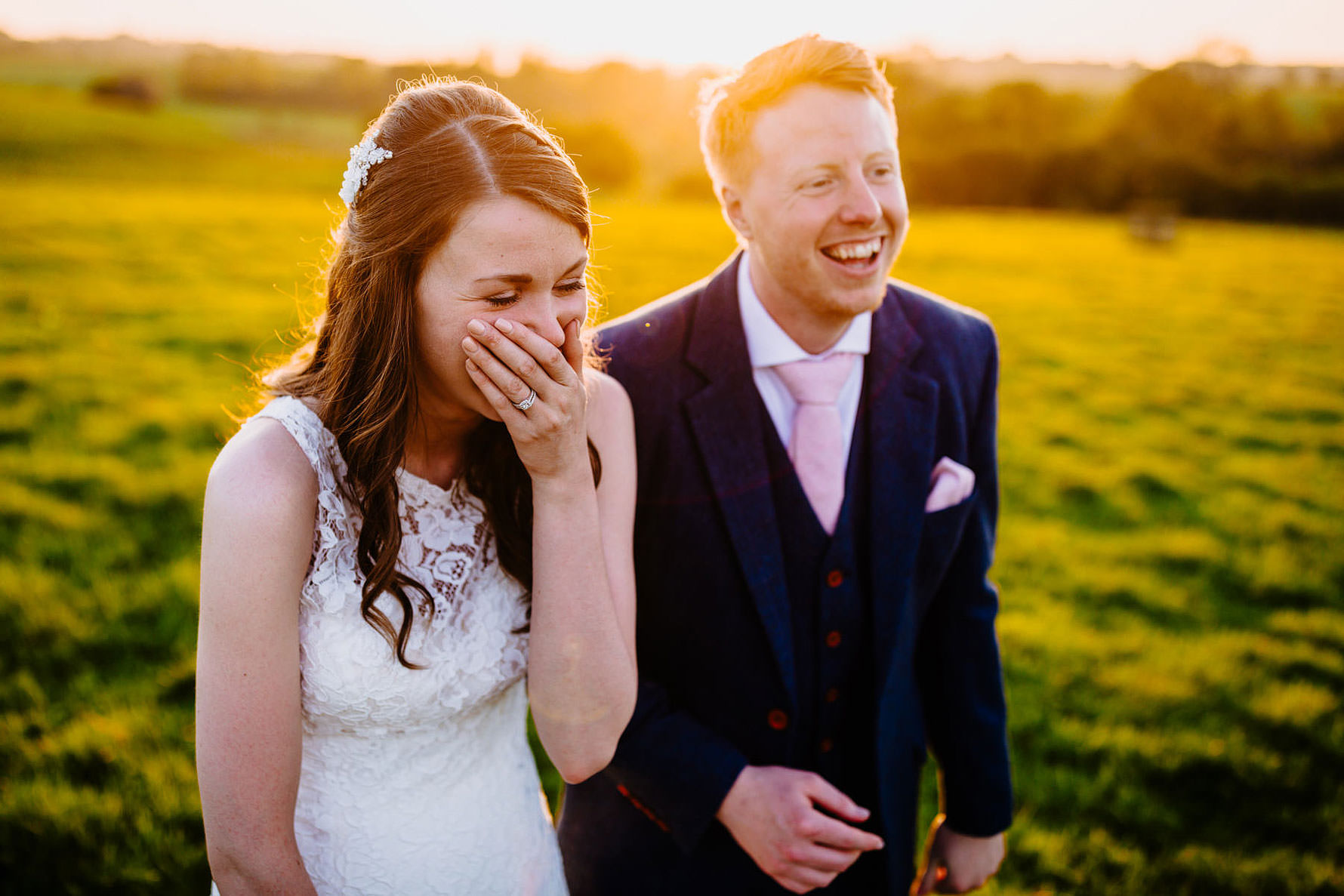 a bride and groom at sunset