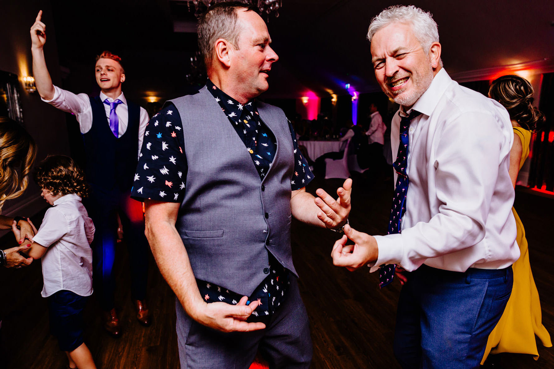 men dancing playing air guitar