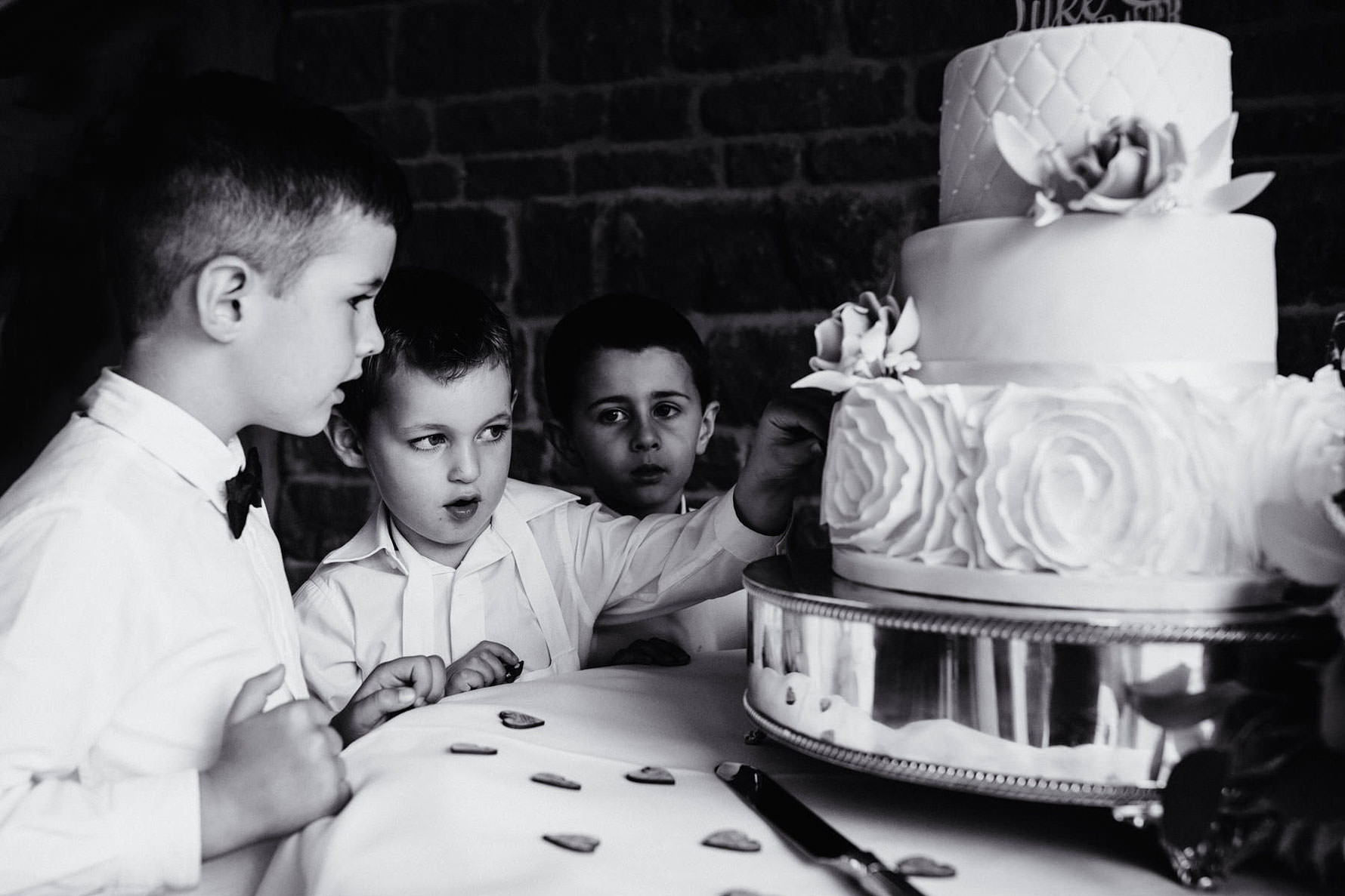 children stealing wedding cake