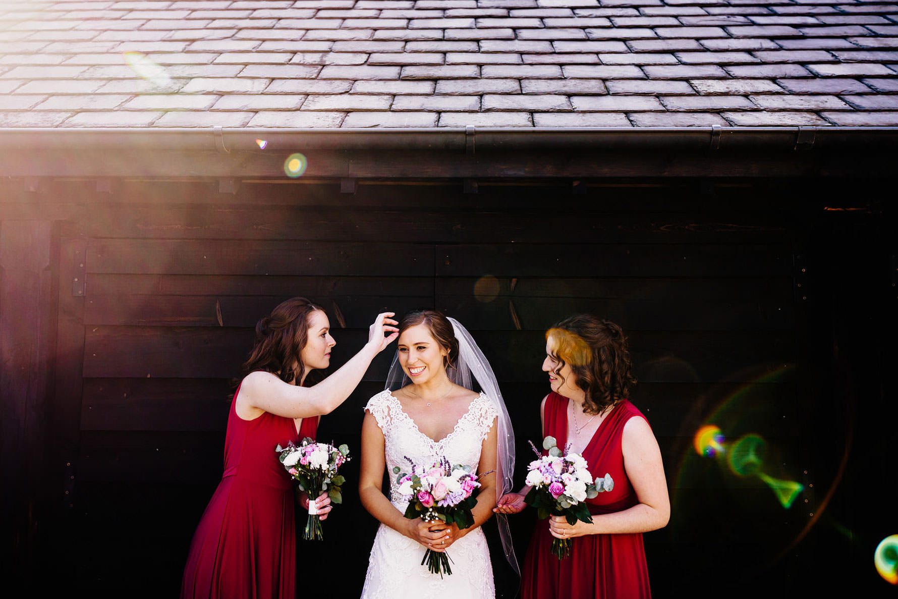 bridesmaid prepare a bride for a photograph