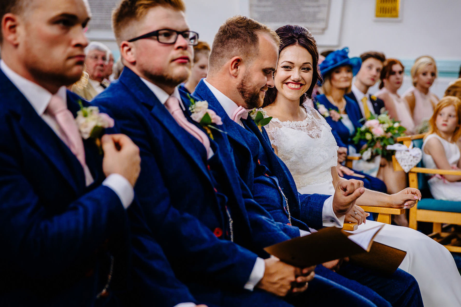 a groom looks at his new wedding ring