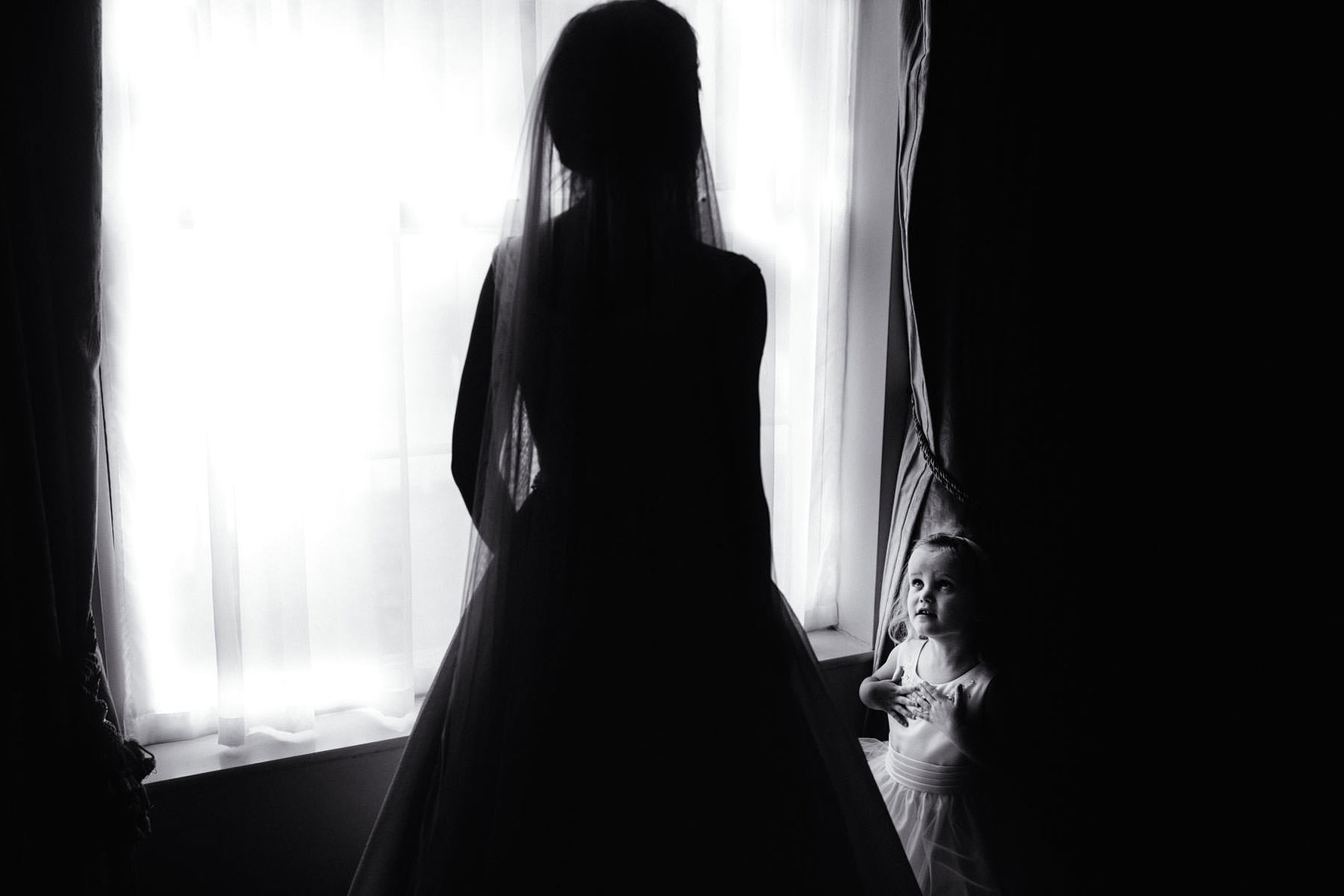 a little girl gazing at a bride