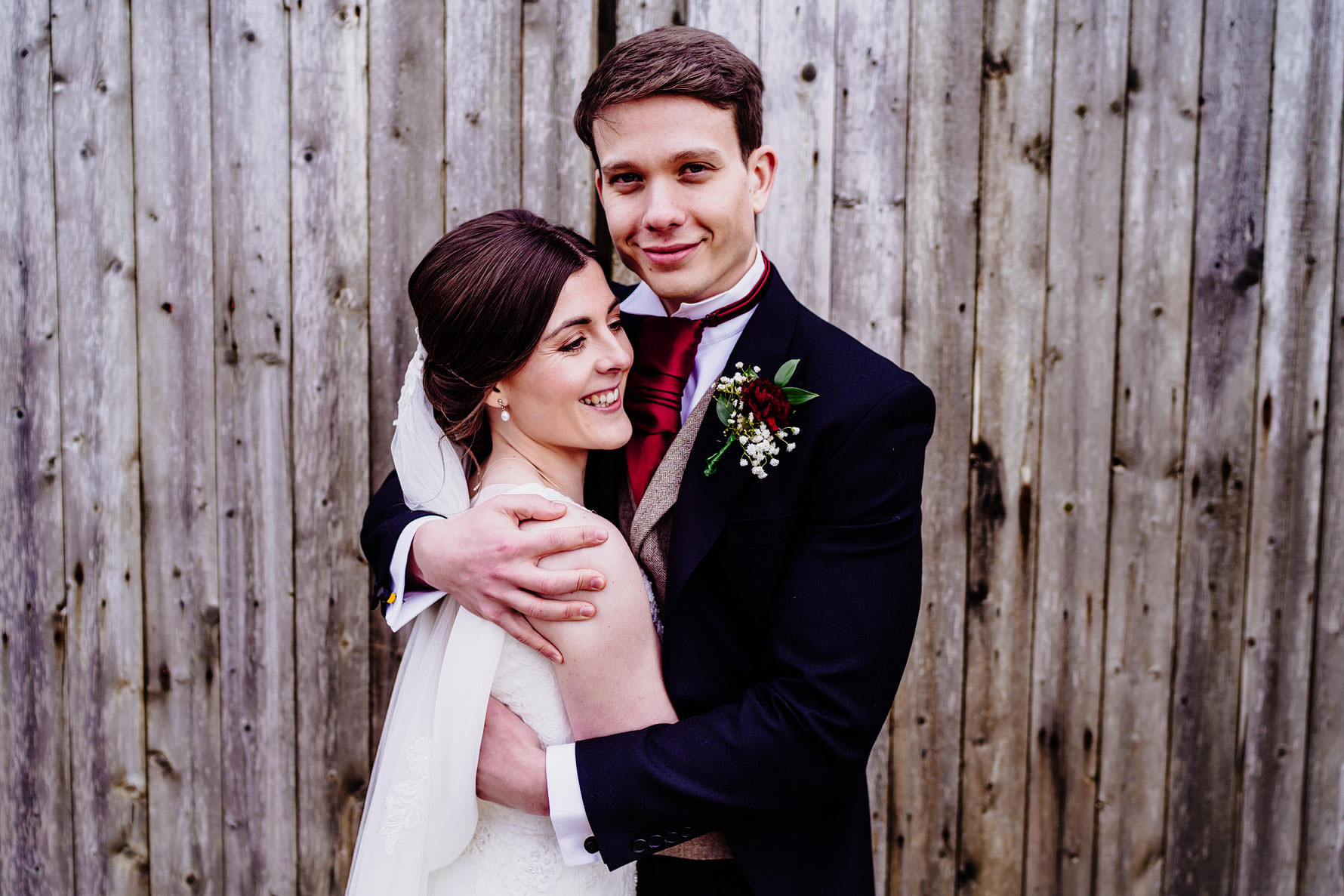 a groom embraces his bride