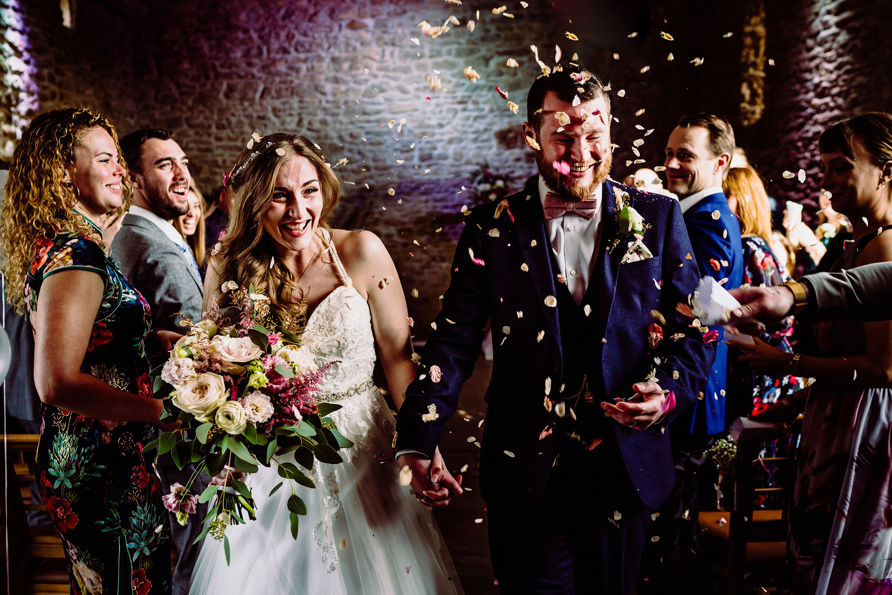 a bring and groom get covered in confetti