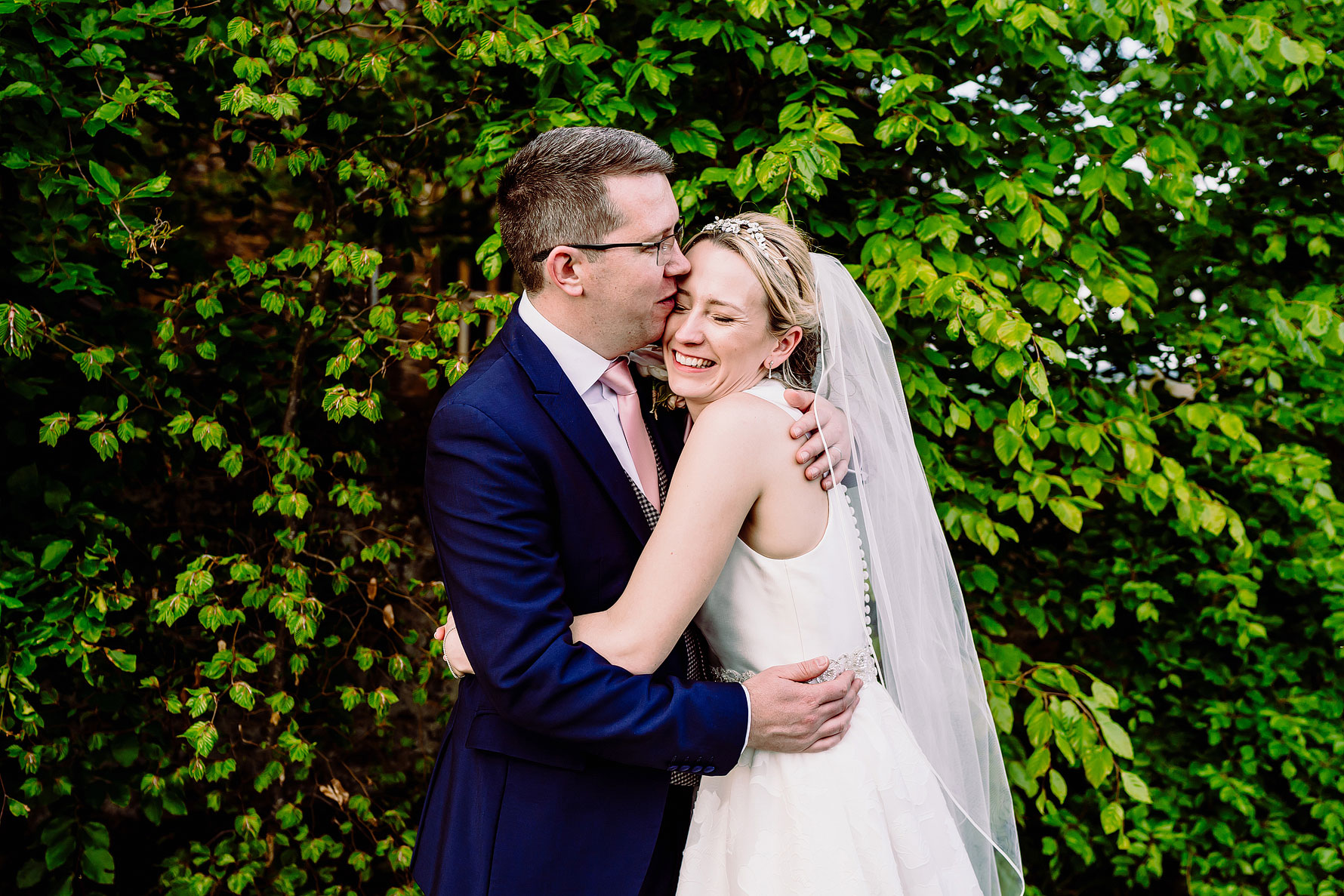 a happy couple embrace on their wedding day