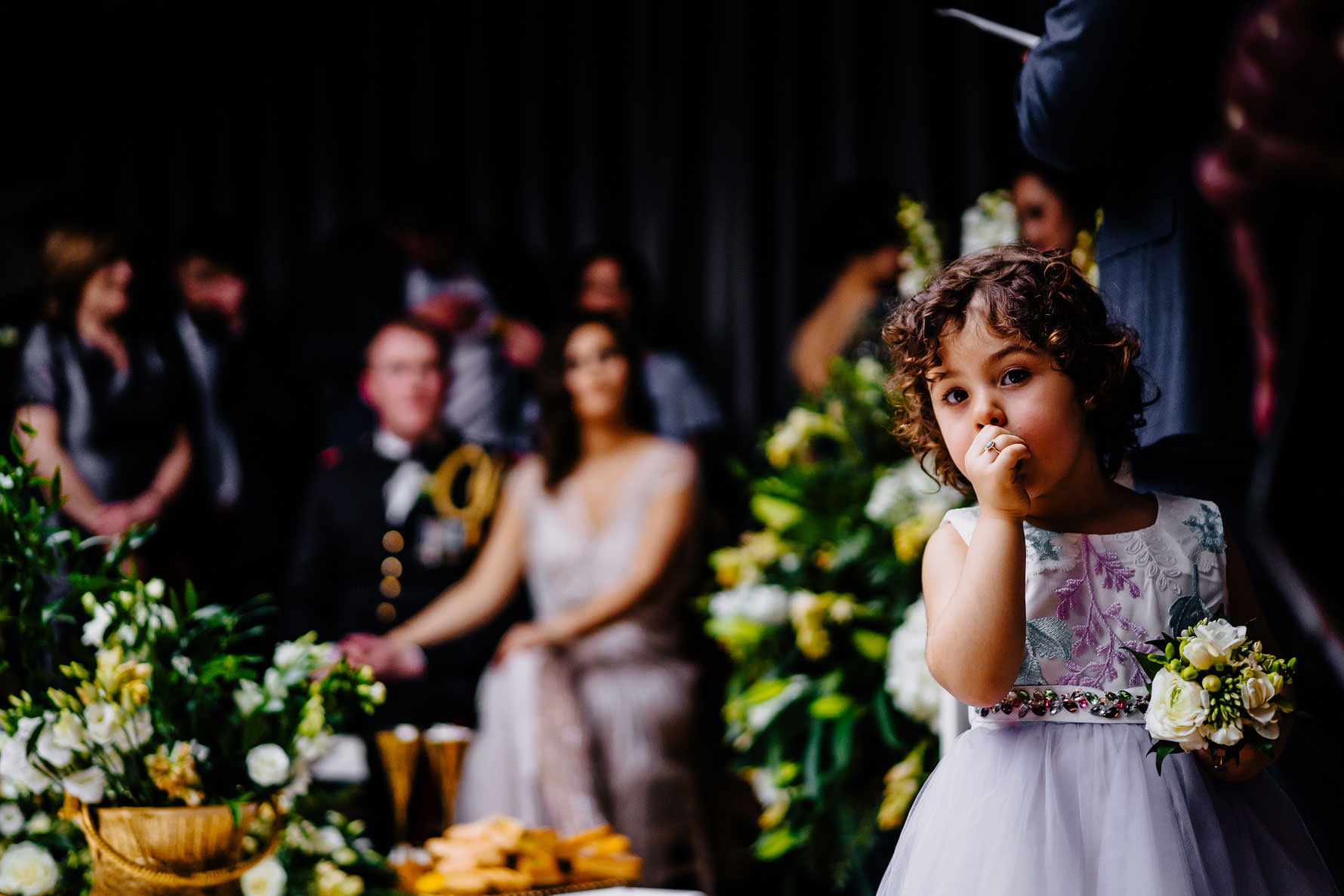 a intrigue flower girl looking at the camera