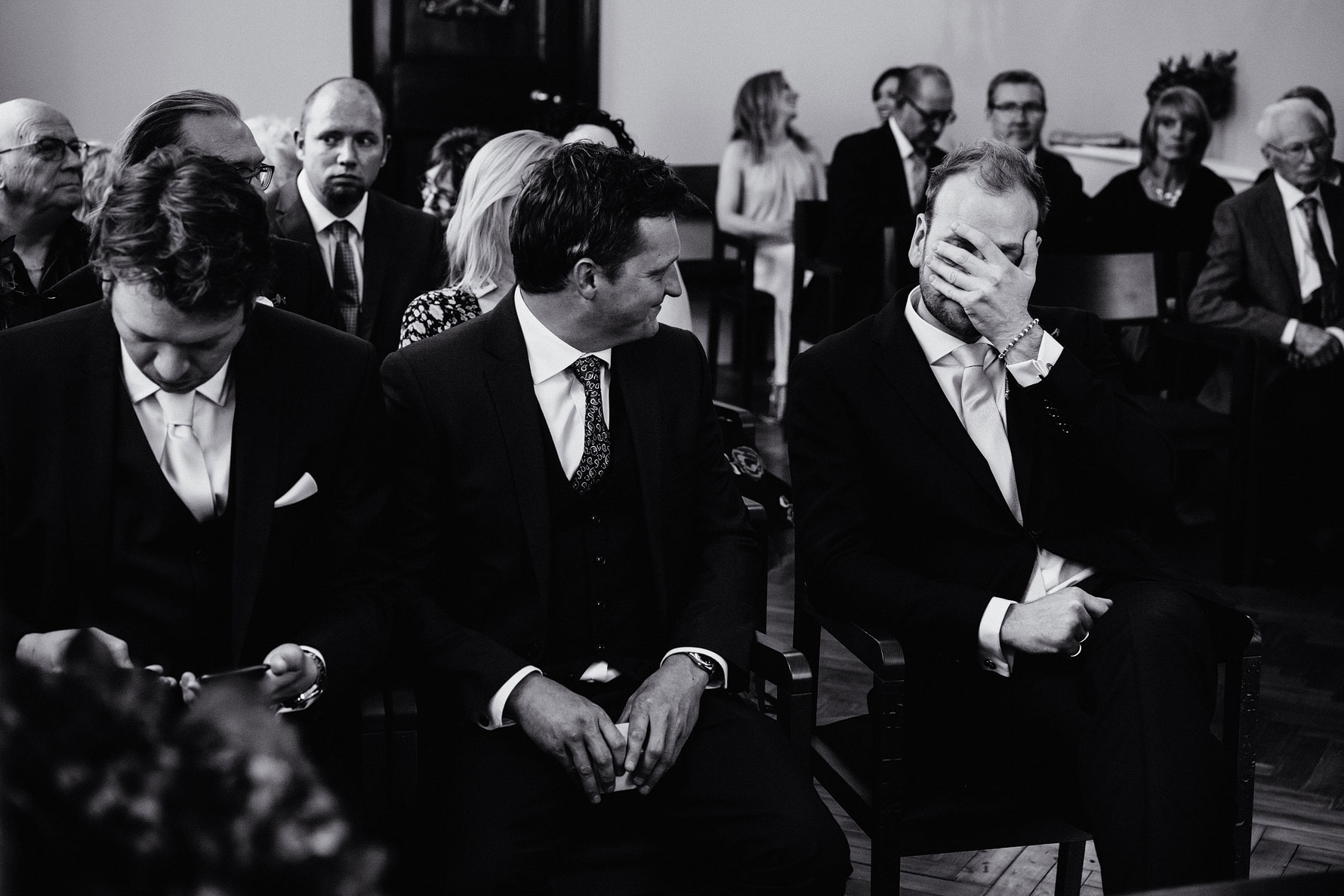 a fun photograph of a groom at his wedding ceremony