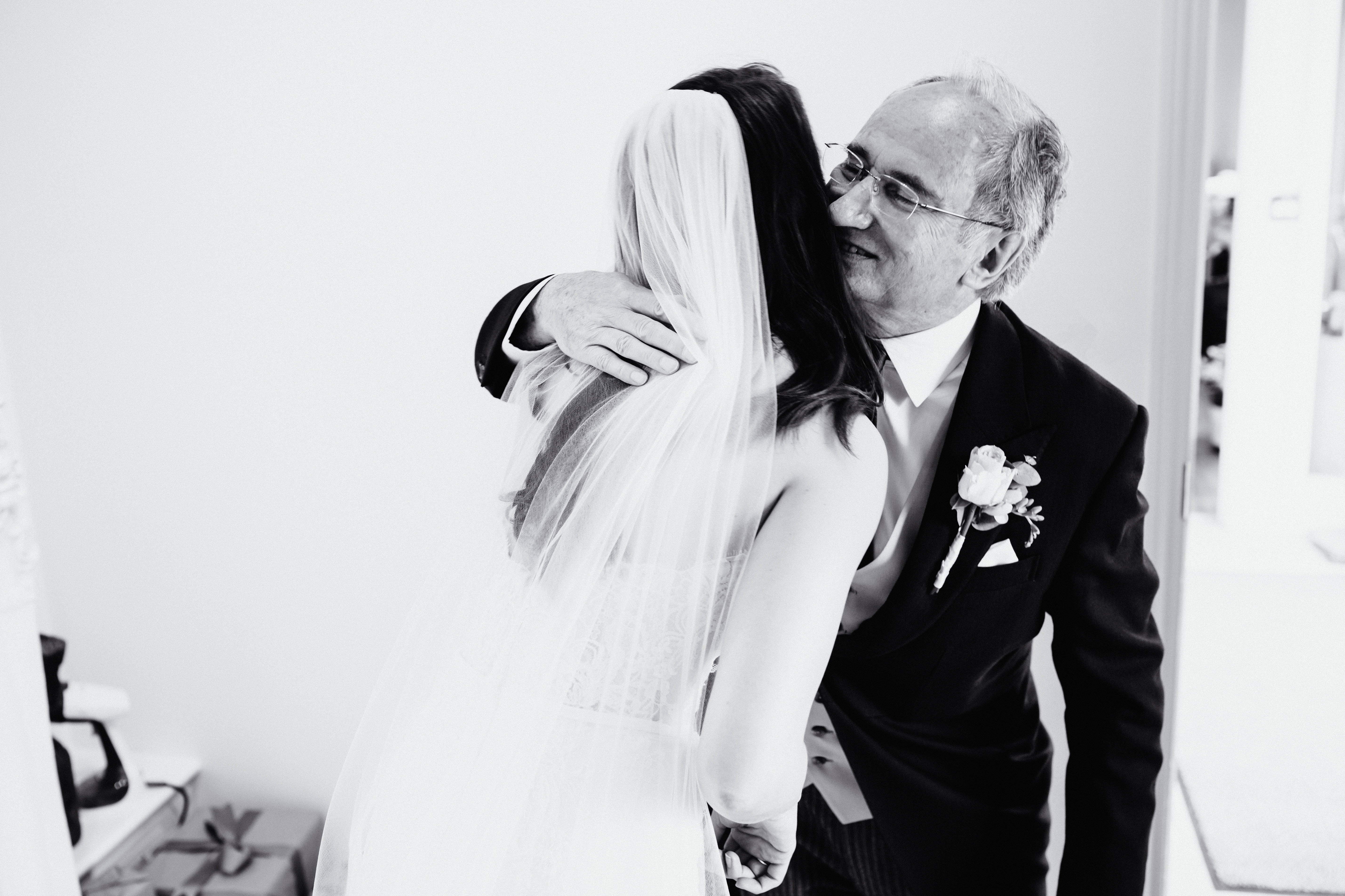 a father of the bride embraces his daughter