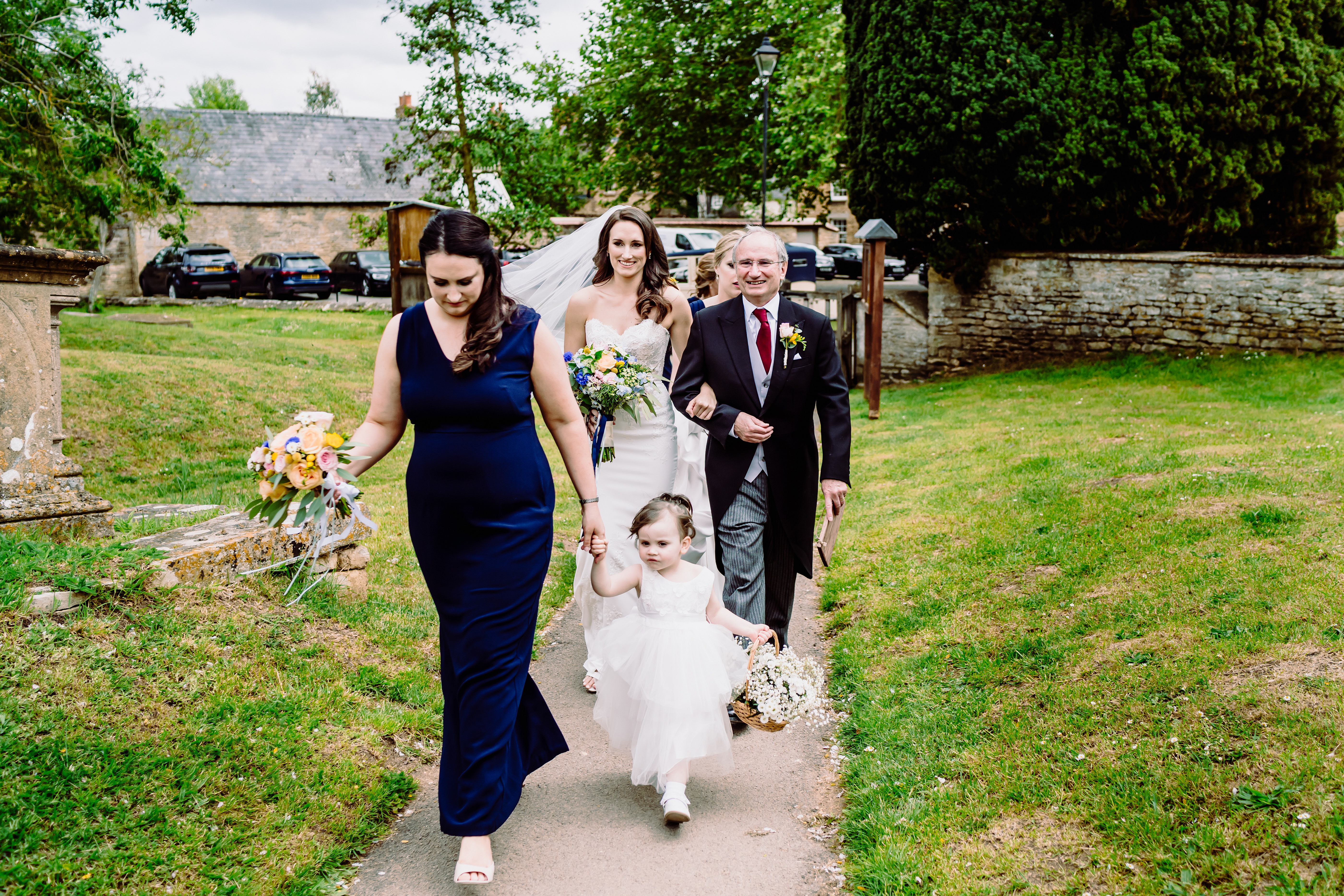 a bride and FOB walk to the church