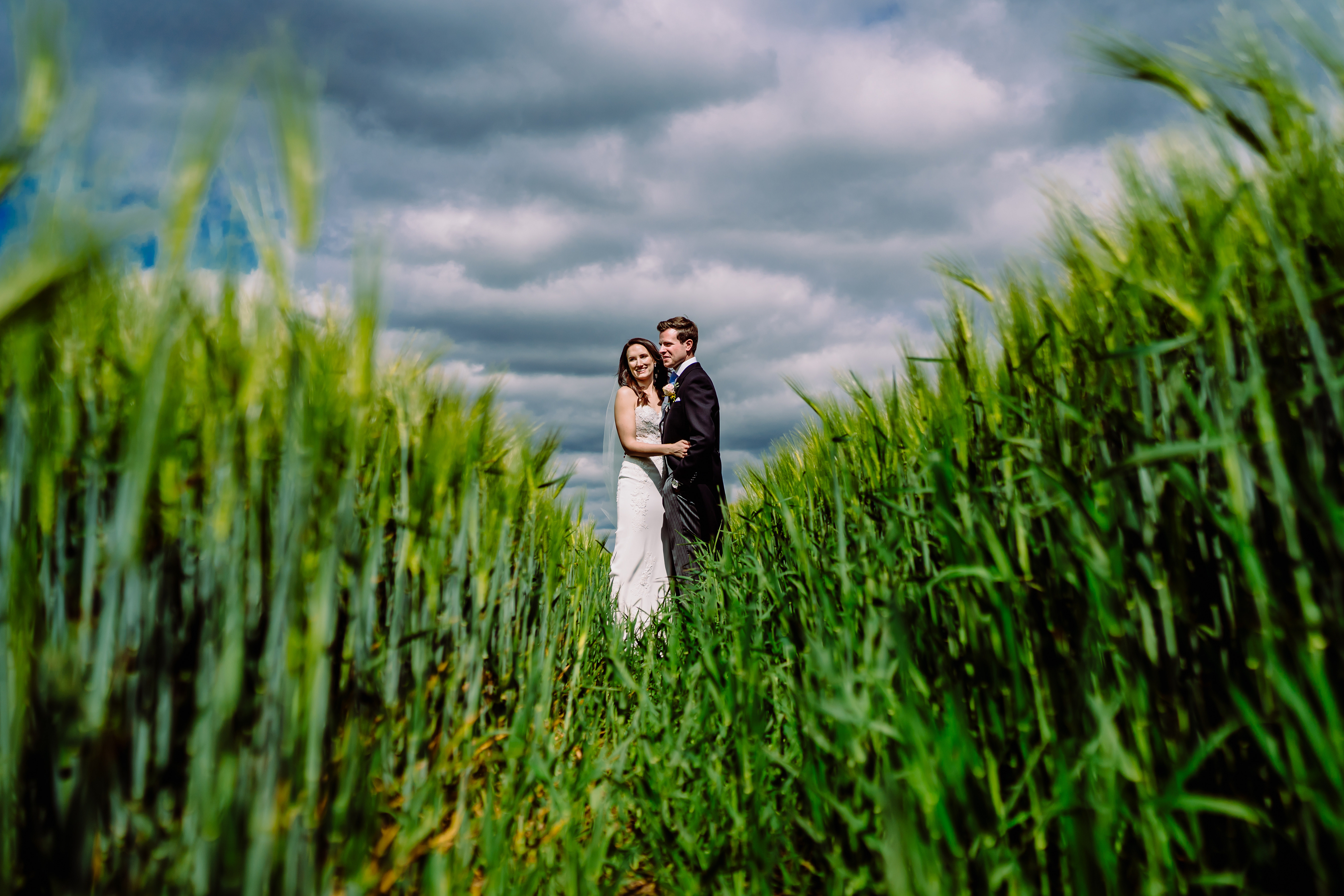 a bride and groom in a field