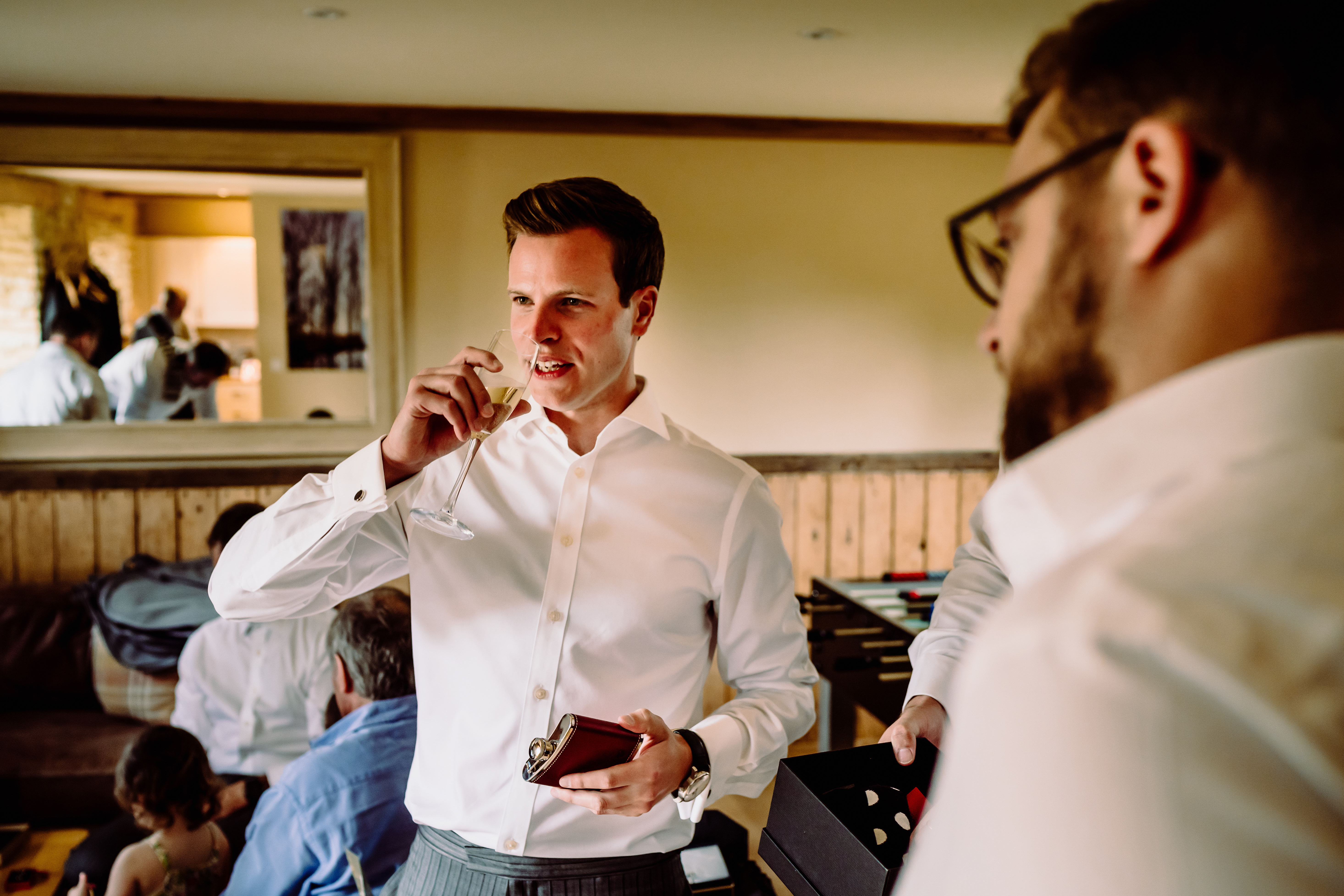 a man drinks champagne at a wedding