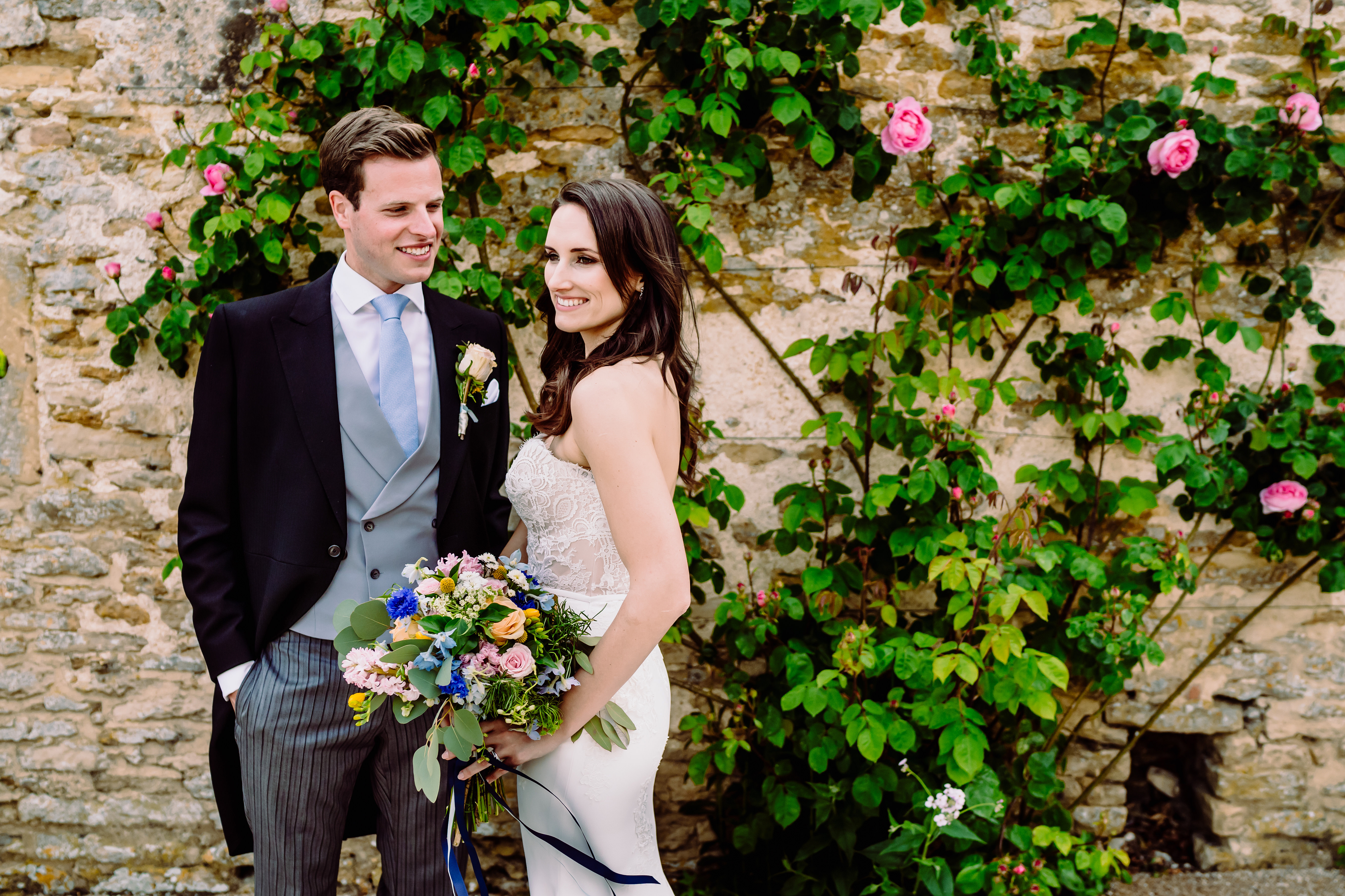 a bride and groom amongst roses