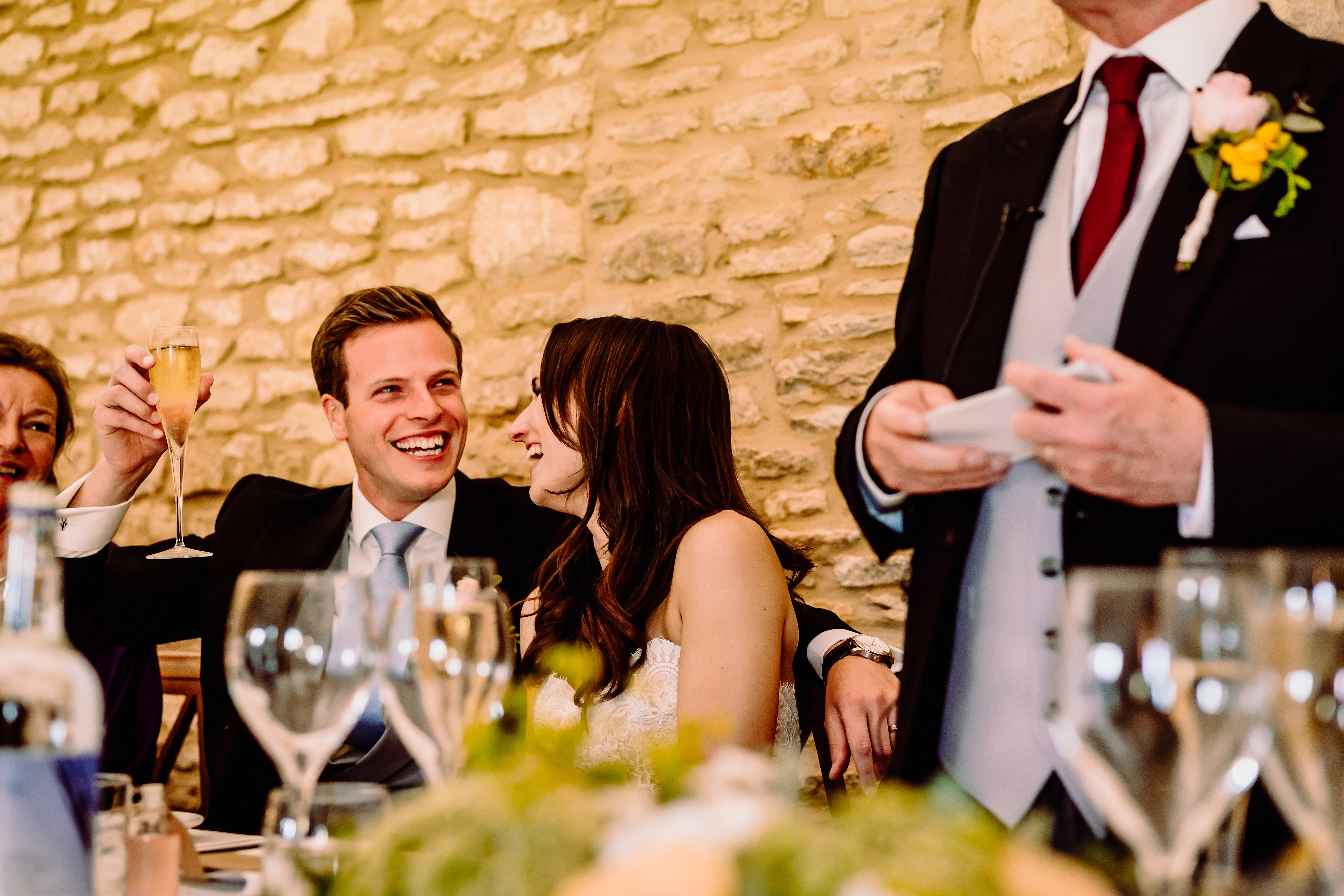 a groom smiles at his father in laws speech