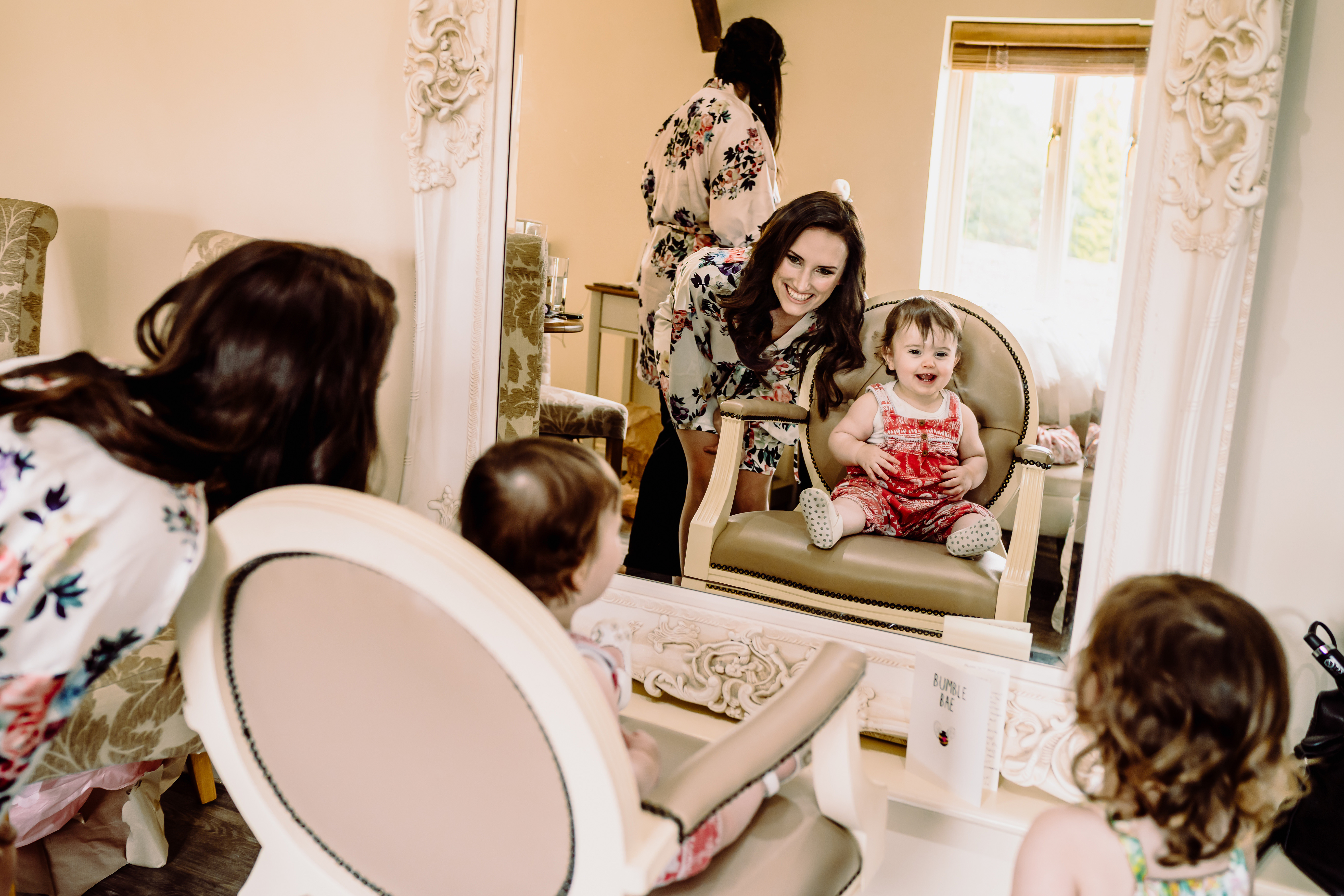 a bride has fun with a flower girl at her wedding