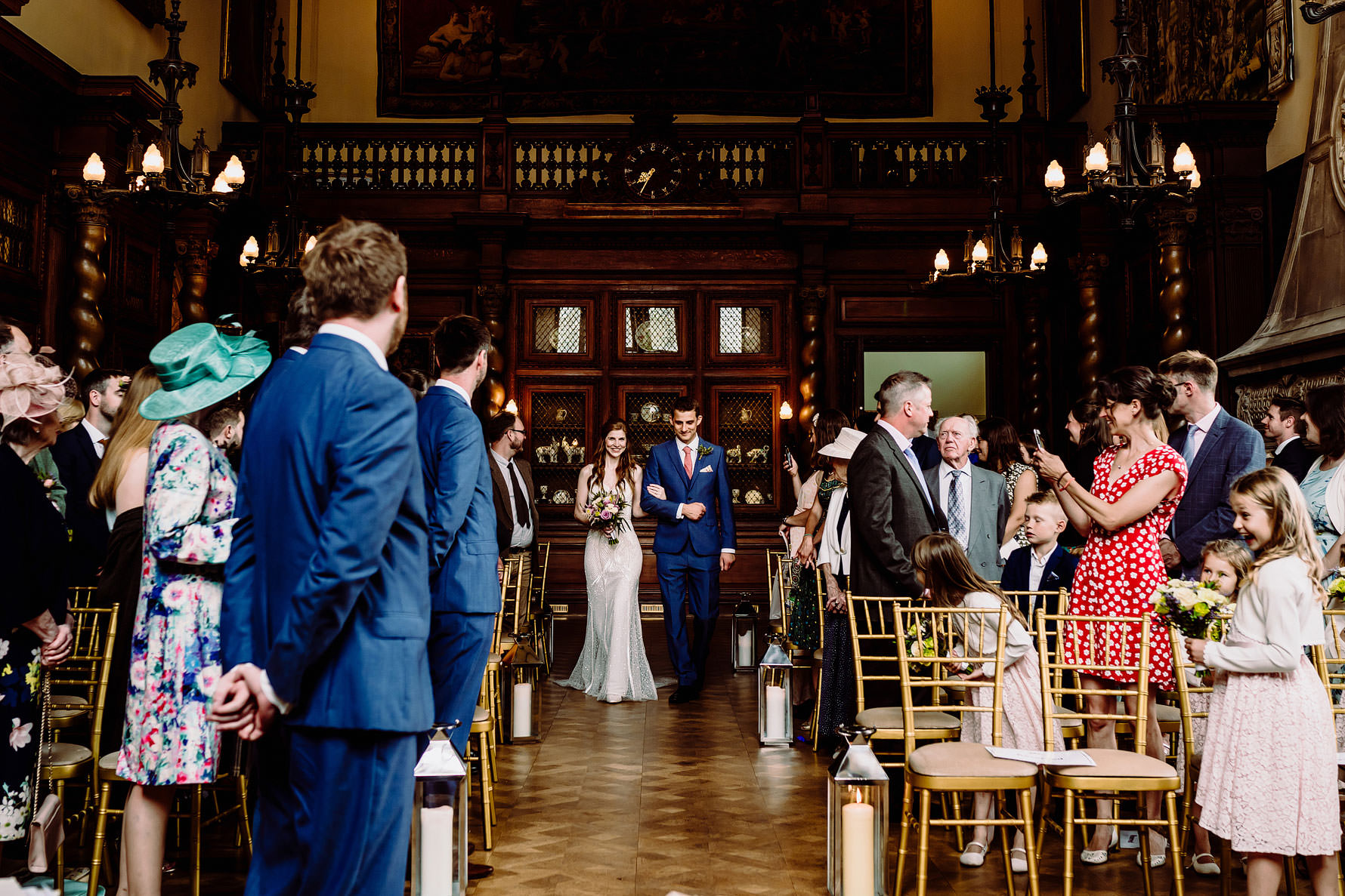 a bride and her brother walking down the aisle