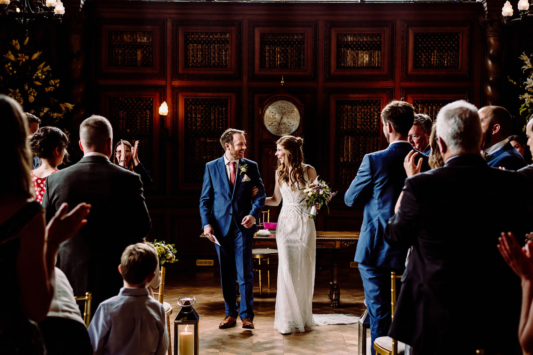 a happy bride and groom walking up the aisle