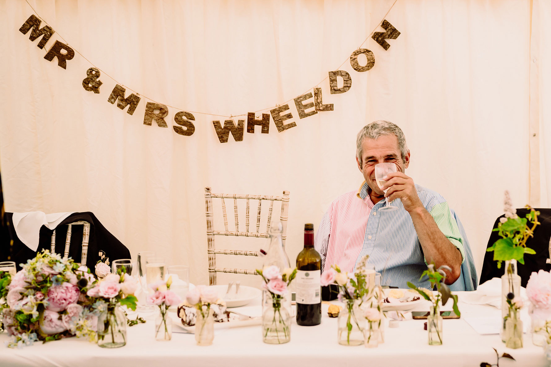 father of the bride drinking wine