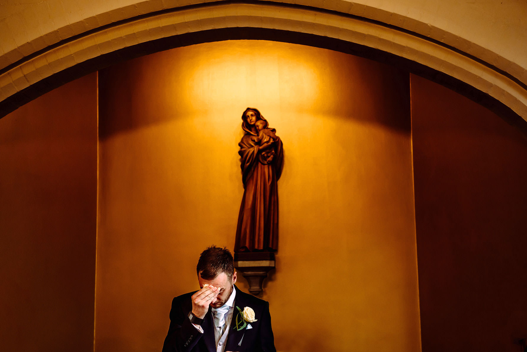 a groom under the Virgin Mary