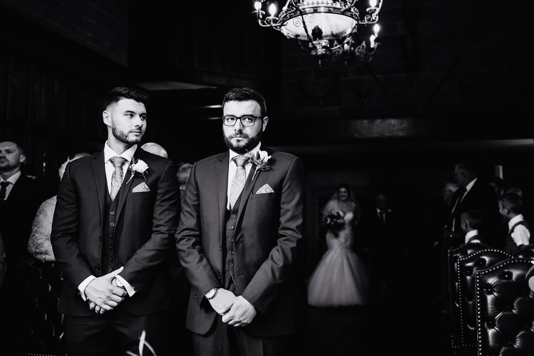 a groom waits for a bride to walk down the aisle