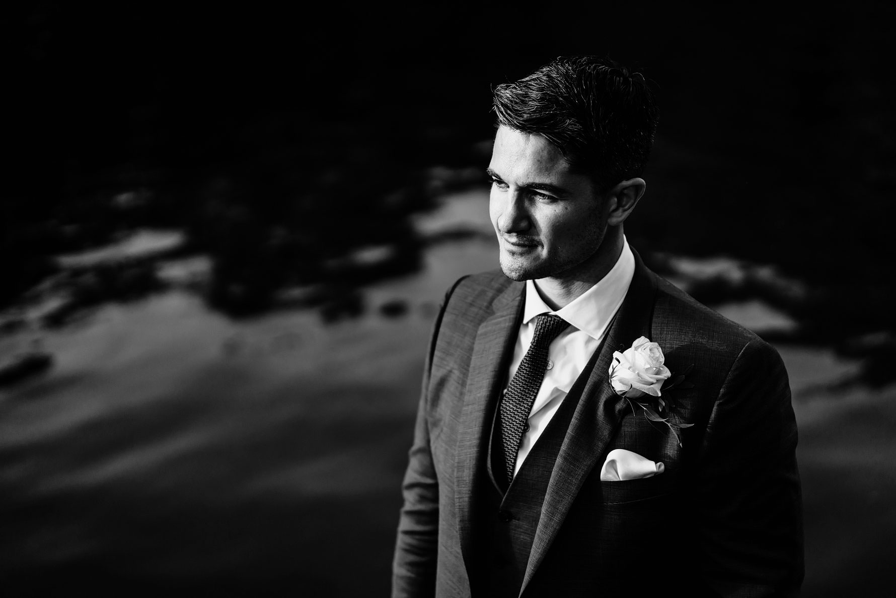 a handsome groom in black and white