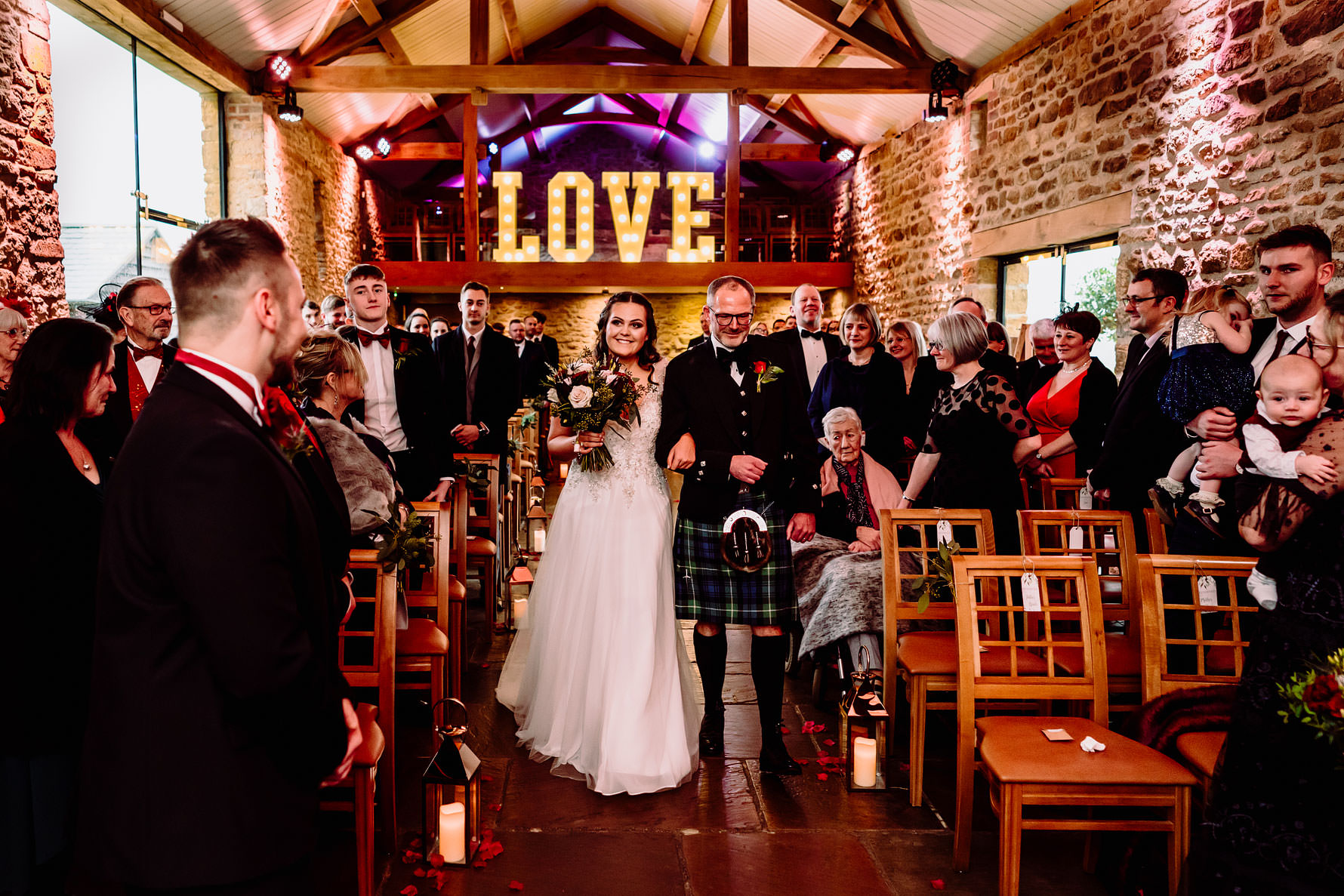 a bride walks down the aisle at her wedding