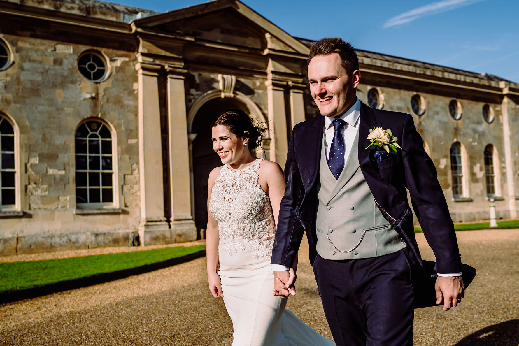 a happy bride and groom holding hands