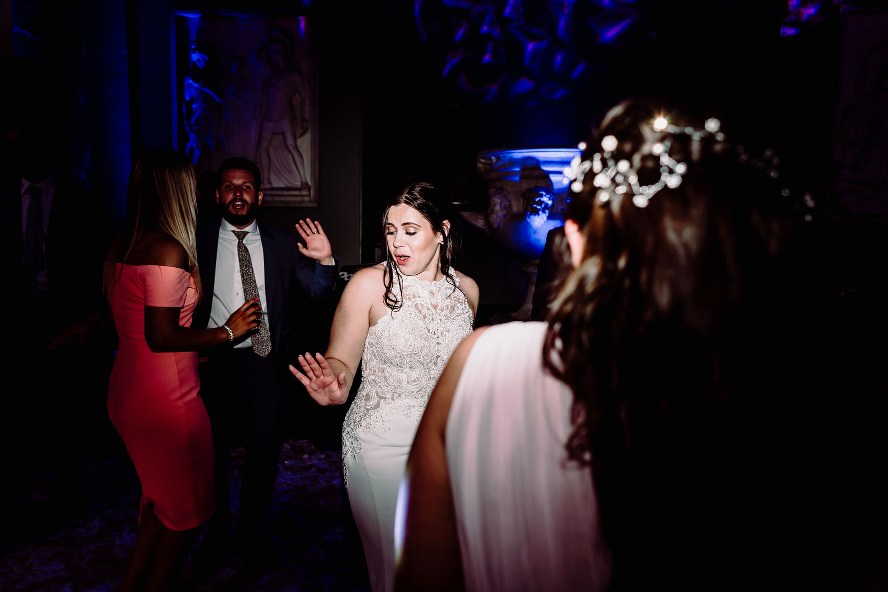 a bride dances with friends