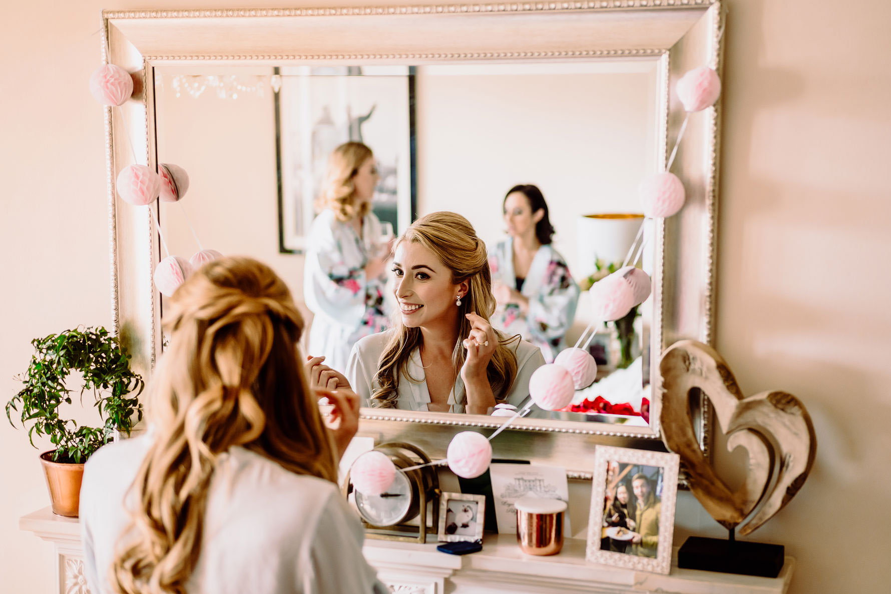 a bride looks in the mirror